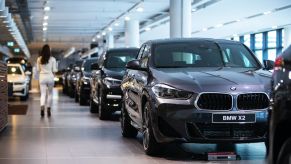 A customer walks through a BMW dealership.