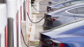 A line of EVs hooked up to public DC fast chargers.