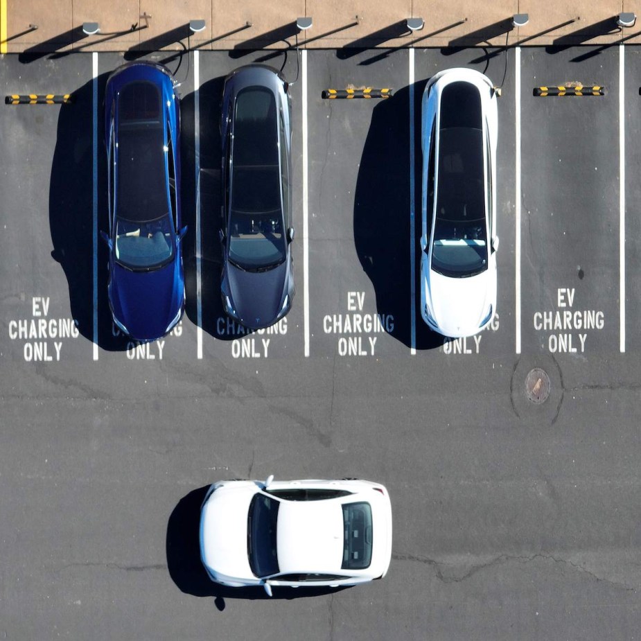 A row of EV charging stations with parking lots that read EV charging only.