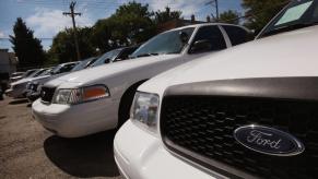 A line of Ford Crown Victoria models in a used car lot in Chicago, Illinois