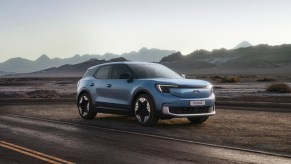 The new Ford Explorer EV rendering on a road with mountains in the background.