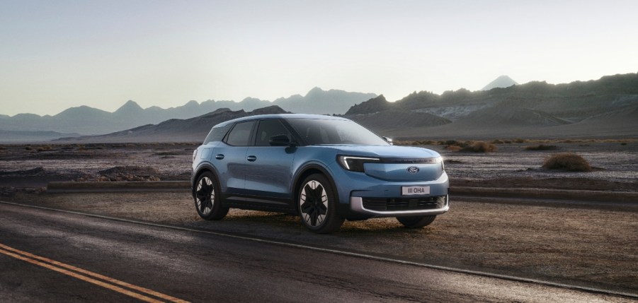 The new Ford Explorer EV rendering on a road with mountains in the background.