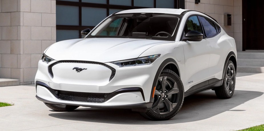 A white 2023 Ford Mustang Mach-E small electric SUV is parked. 