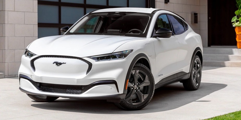 A white 2023 Ford Mustang Mach-E small electric SUV is parked. 