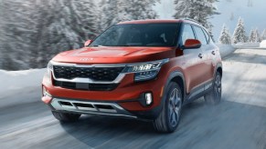 Front angle view of orange 2023 Kia Seltos crossover SUV