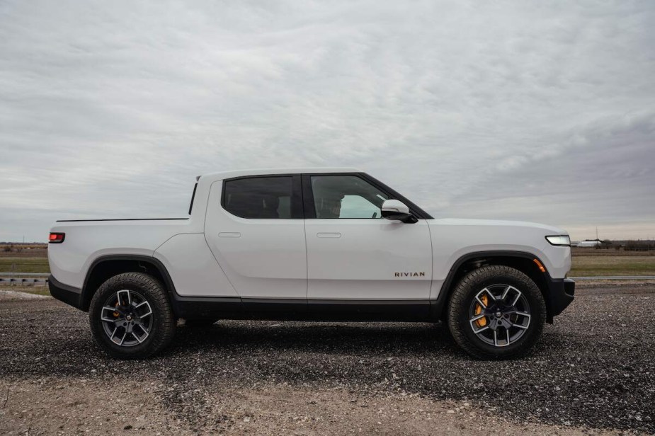 A white Rivian R1T parked outdoors.