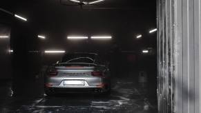 Porsche in a car wash bay