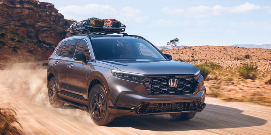 A gray 2023 Honda CR-V small SUV is driving off-road. 