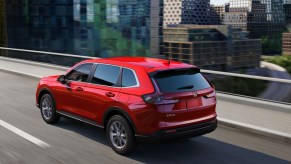 A red Honda CR-V driving down the highway.