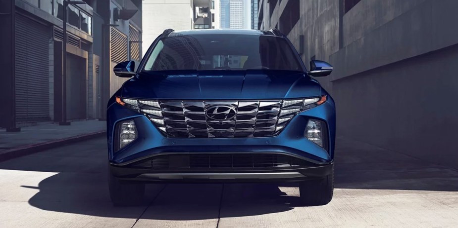 A blue 2023 Hyundai Tucson Hybrid small hybrid SUV is parked. 