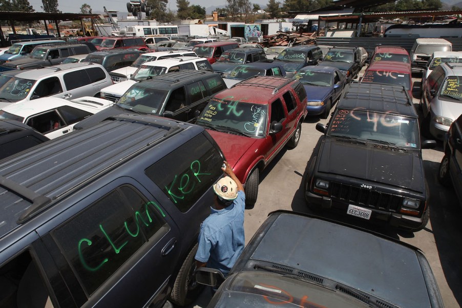 a junk yard filled with scrap cars that will never be collectible