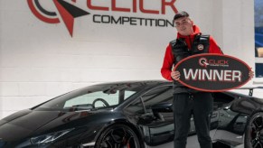 Lamborghini Hurracan Winner pictured standing next to his black supercar.