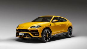 A yellow Lamborghini Urus SUV shows off its dramatic front-end styling.