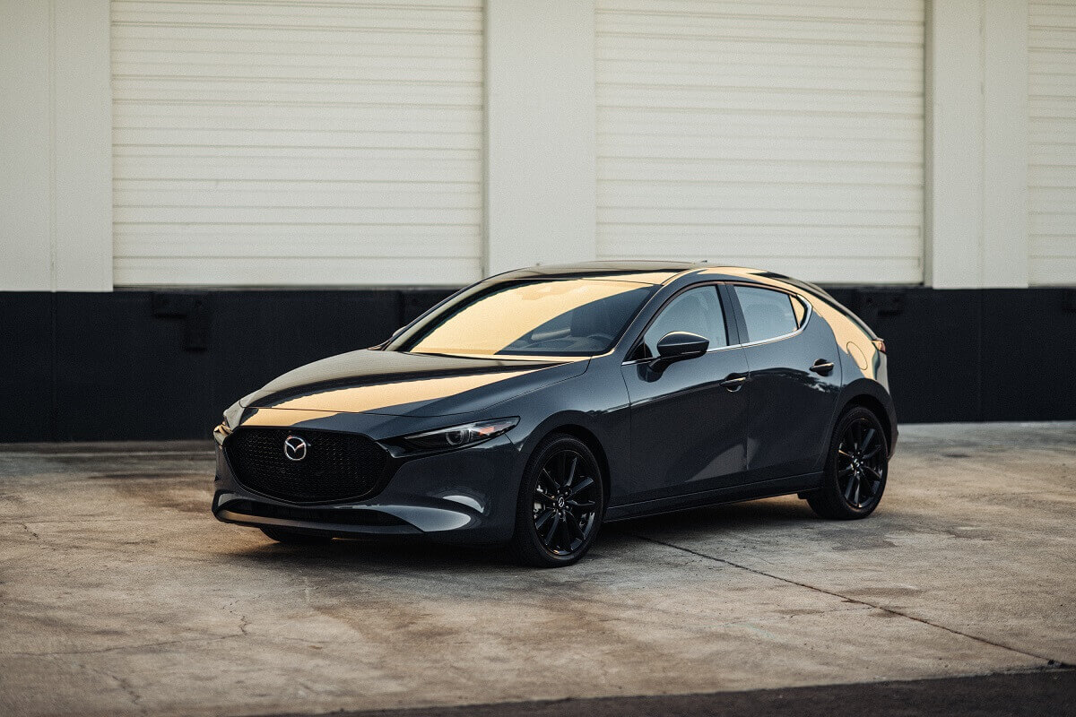 A gray 2023 Mazda3 shows off its hatchback car proportions.