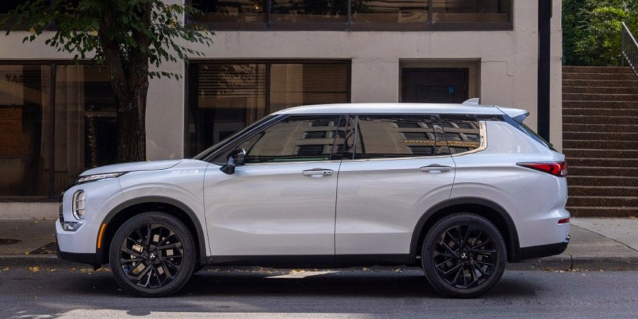 A white 2023 Mitsubishi Outlander small SUV is parked.