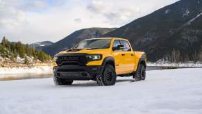 A yellow Ram 1500 parked outdoors.