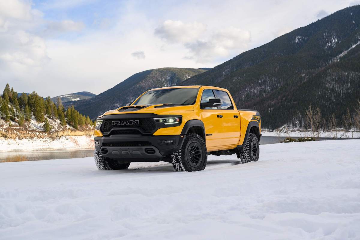 A yellow Ram 1500 parked outdoors.