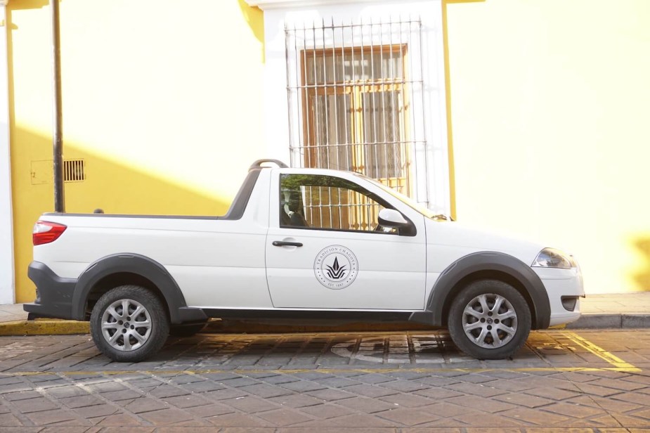 A white Ram 700 two-door compact truck in profile.