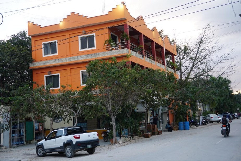 An extended-cab Ram 700 in front of an orange building in Mexico.