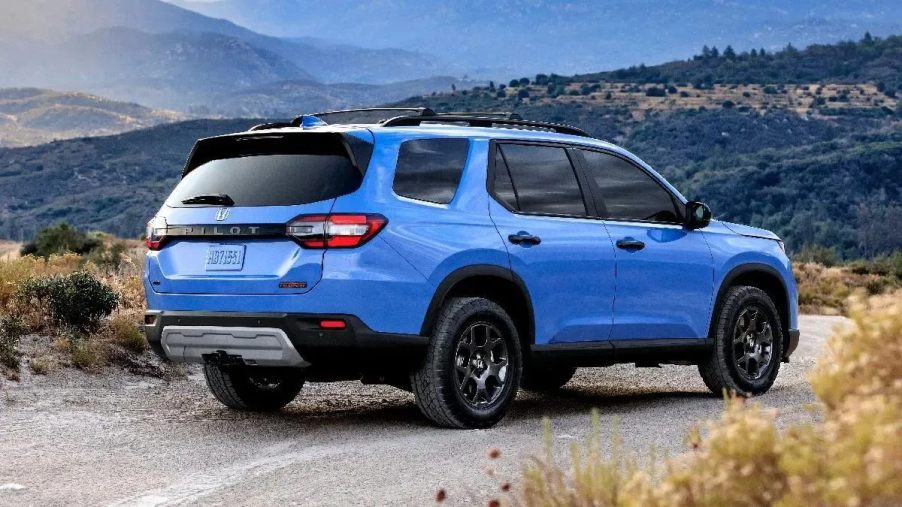 Rear angle view of blue 2023 Honda Pilot midsize SUV