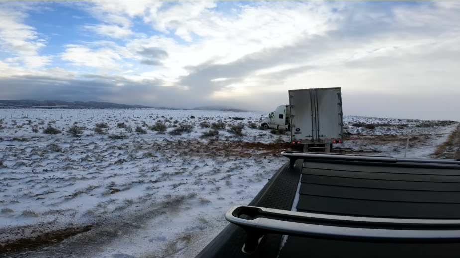 Rivian R1T tows Semi-truck out of a ditch.