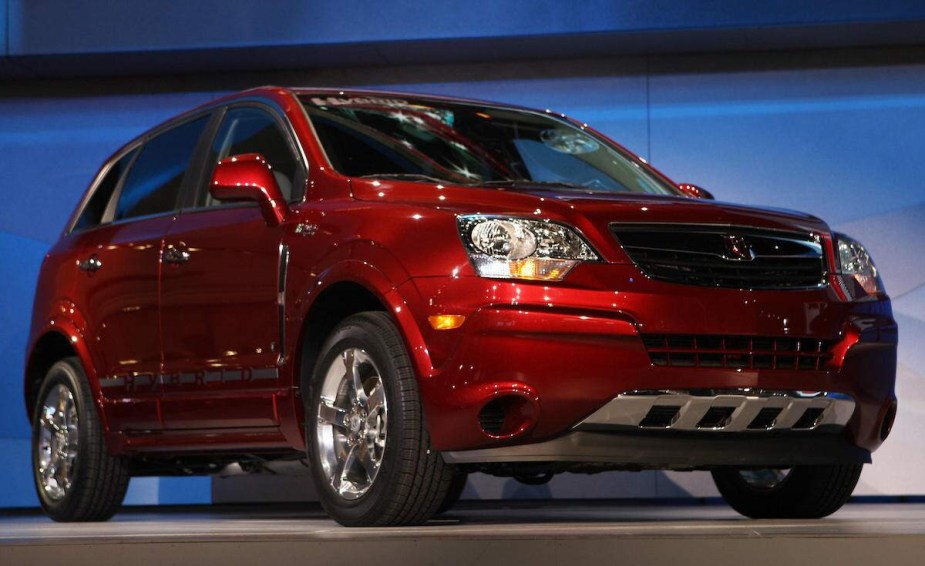 A red Saturn Vue parked indoors. 