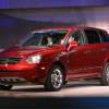 A red Saturn Vue parked indoors.