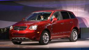 A red Saturn Vue parked indoors.