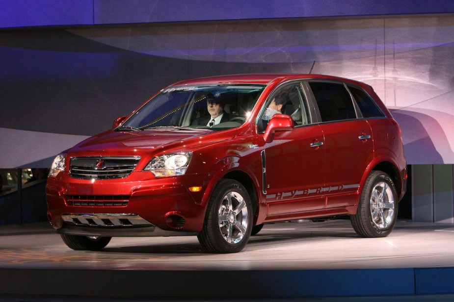 A red Saturn Vue parked indoors. 