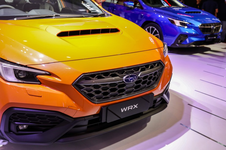 A yellow Subaru WRX parked indoors.