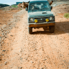 Peter Corn and Neal Thompson driving a second-gen Suzuki Jimny through Moab