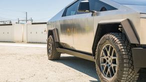 Detail shot of Tesla's new Cybertruck parked outside a factory.