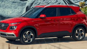 A red 2023 Hyundai Venue subcompact SUV is parked.