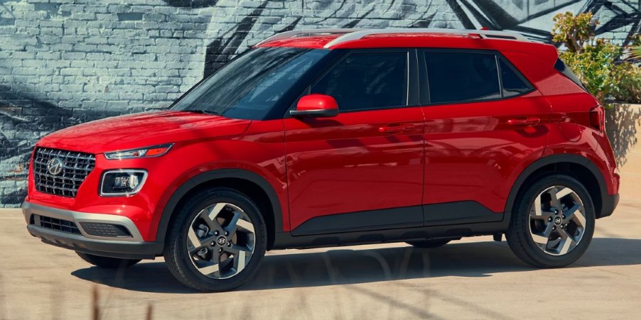 A red 2023 Hyundai Venue subcompact SUV is parked.