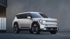 A white 2024 Kia EV9 midsize electric SUV is parked.