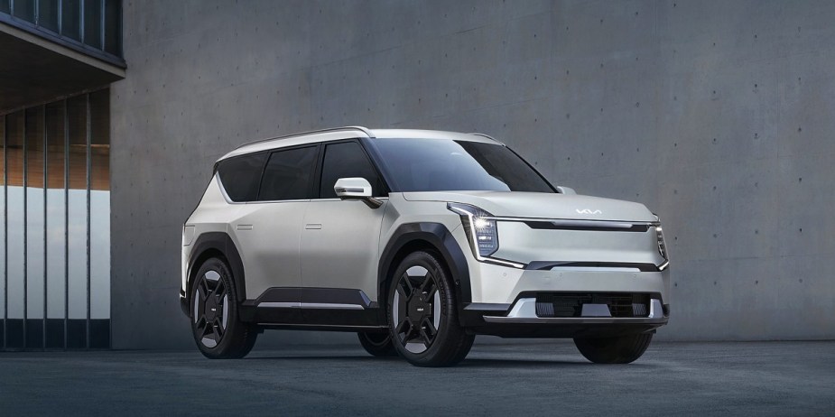 A white 2024 Kia EV9 midsize electric SUV is parked. 