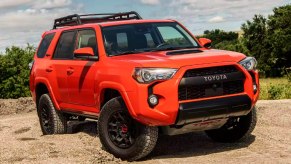 An orange 2023 Toyota 4 Runner is parked.