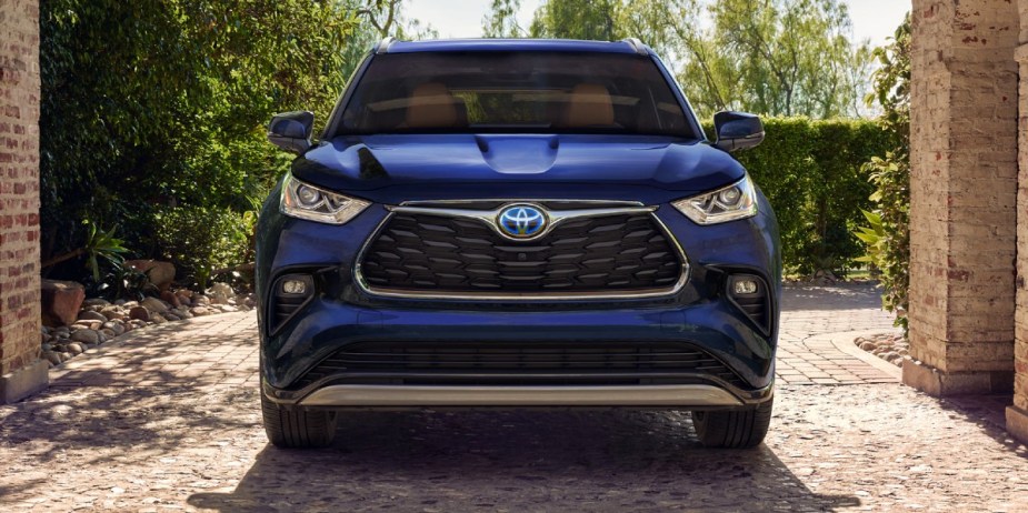 A blue 2023 Toyota Highlander Hybrid midsize SUV is parked. 