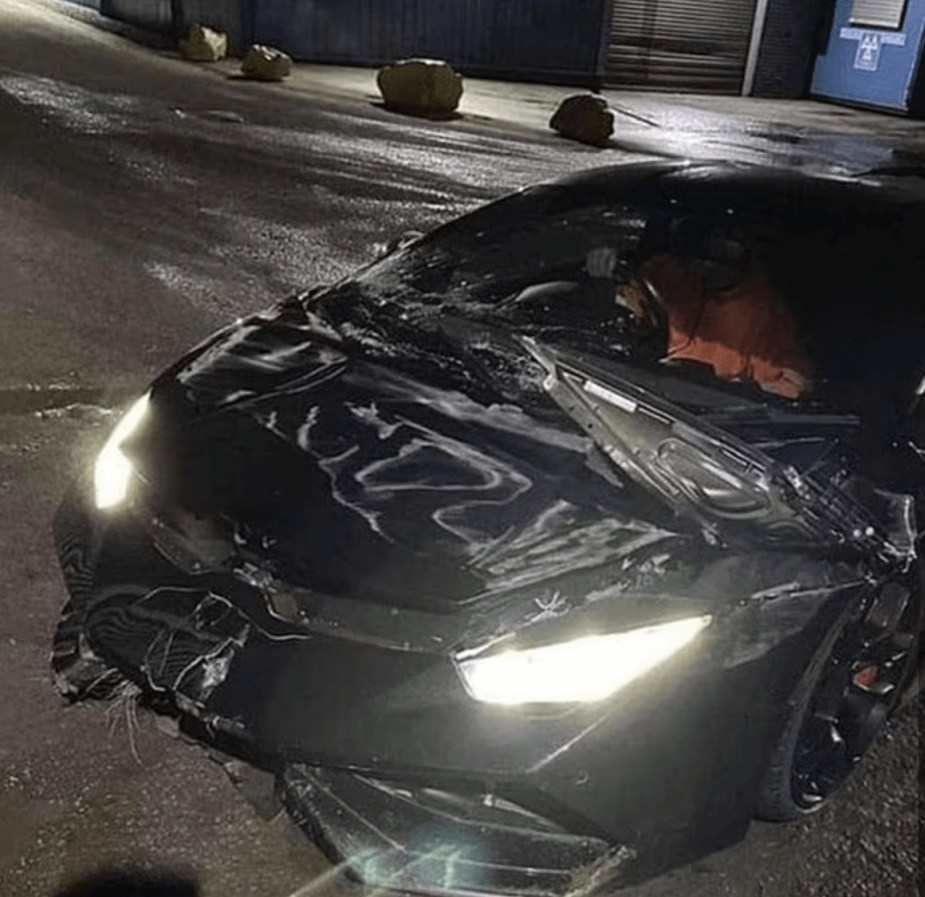 A Lamborghini Huracan with a busted up hood and quarter panel 