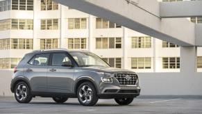 A gray 2023 Hyundai Venue subcompact SUV model on the top of a parking structure