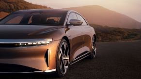 A Lucid Air luxury electric car driving down a road.