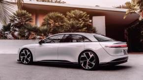 A Lucid Air parked in the driveway of a home.