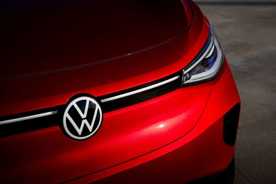 A shot of the hood, headlights, and logo/emblem of a red 2023 Volkswagen ID.4 electric compact SUV model