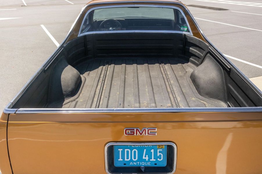 The bed of a GMC Caballero coupe utility classic muscle truck, in a parking lot.