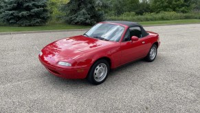 The pristine red 1990 Mazda Miata on Bring a Trailer