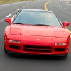 A head-on view of the 1991 Acura NSX driving down a road