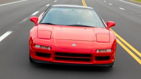 A head-on view of the 1991 Acura NSX driving down a road