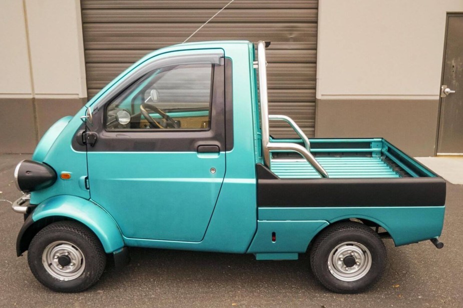 Profile view of the single-seat Daihatsu Midget II compact pickup truck.