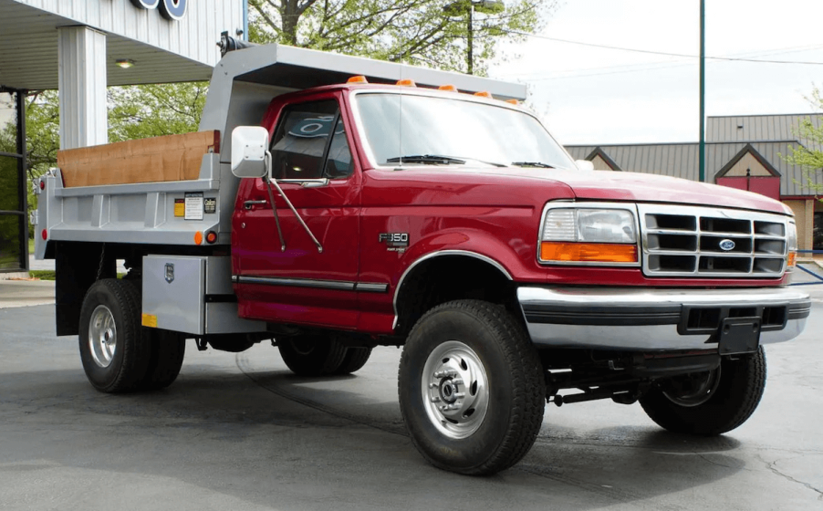 Red 1997 Ford F-350 dump bed truck with 1,500 miles