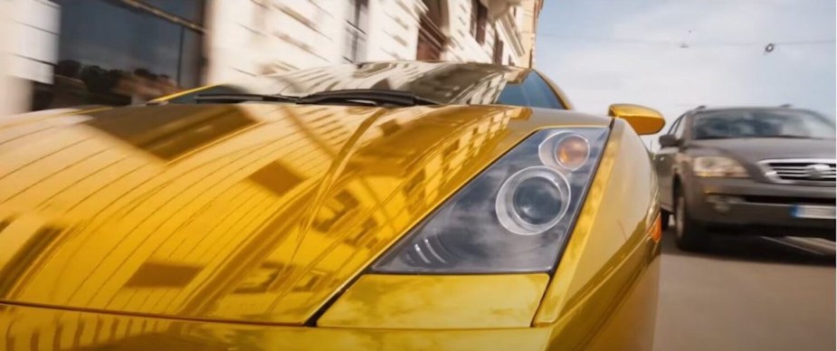 Closeup of the headlight of a gold-plated 2003 Lamborghini Gallardo from Fast and Furious 10.